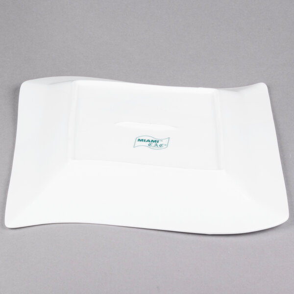A CAC Miami white square porcelain plate with a logo on it.