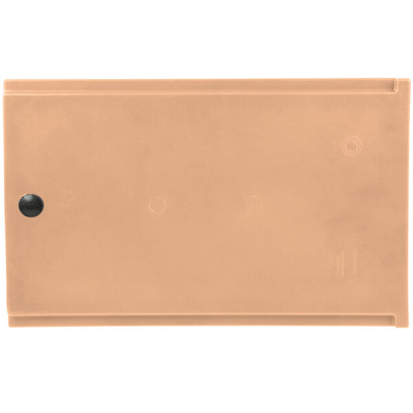 A rectangular beige plastic box with a round black circle on it.