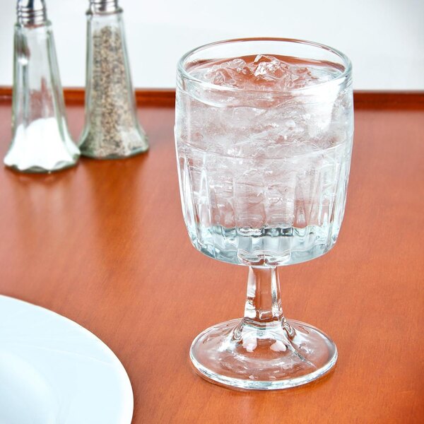 An Anchor Hocking Breckenridge goblet of ice water on a table.