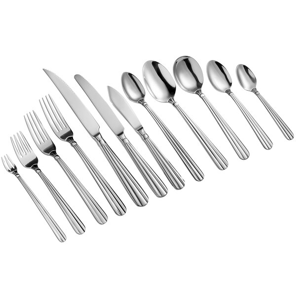 A close-up of several Acopa stainless steel oval bowl dinner/dessert spoons.