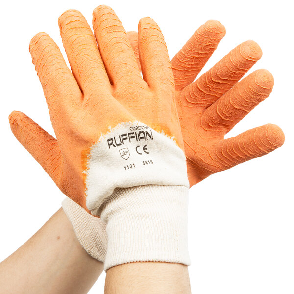 A pair of hands wearing Cordova Ruffian orange gloves with white and orange palms.