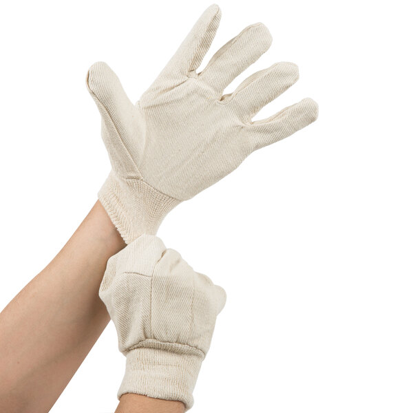 A person wearing Cordova Standard Weight cotton canvas work gloves.