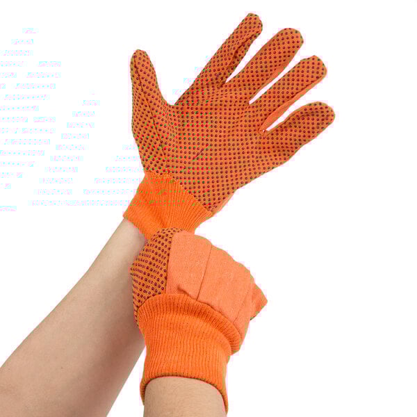 A pair of large orange Cordova canvas work gloves with black PVC dots.