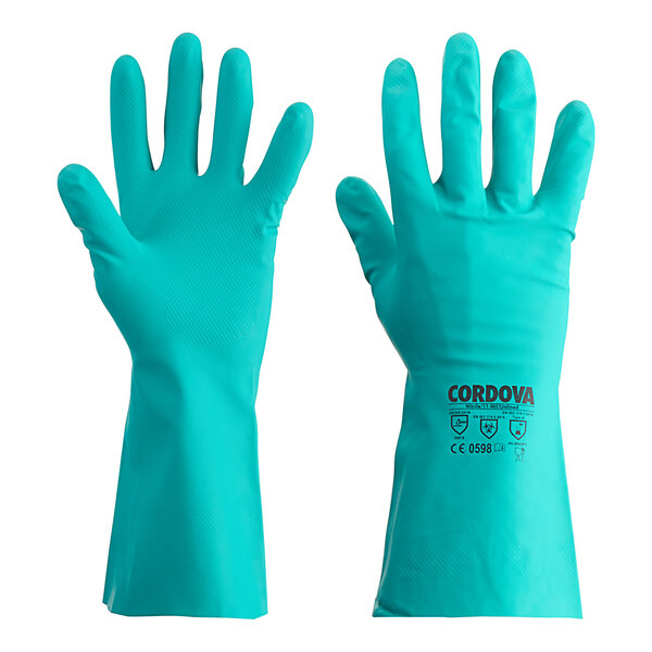 A gloved hand wearing a green Cordova Nitrile glove.