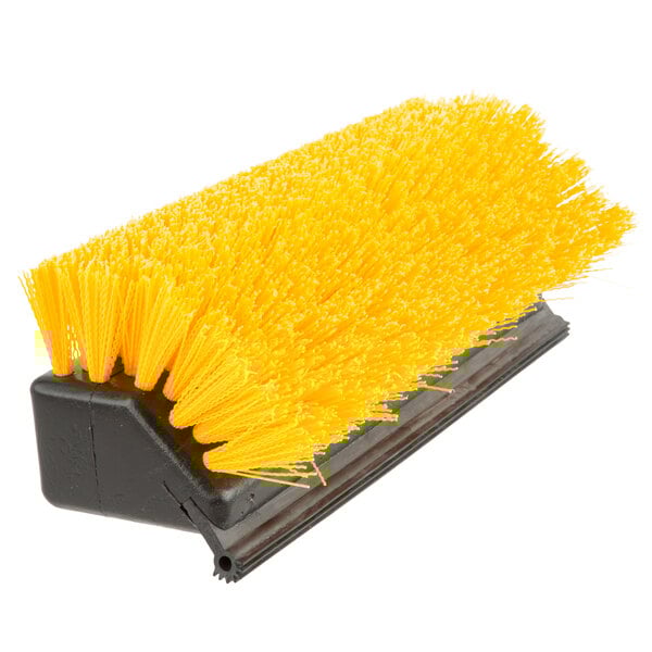 A Carlisle yellow deck brush with black bristles.