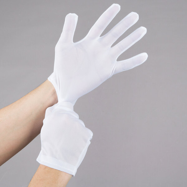 A person wearing white Cordova Inspector's gloves.
