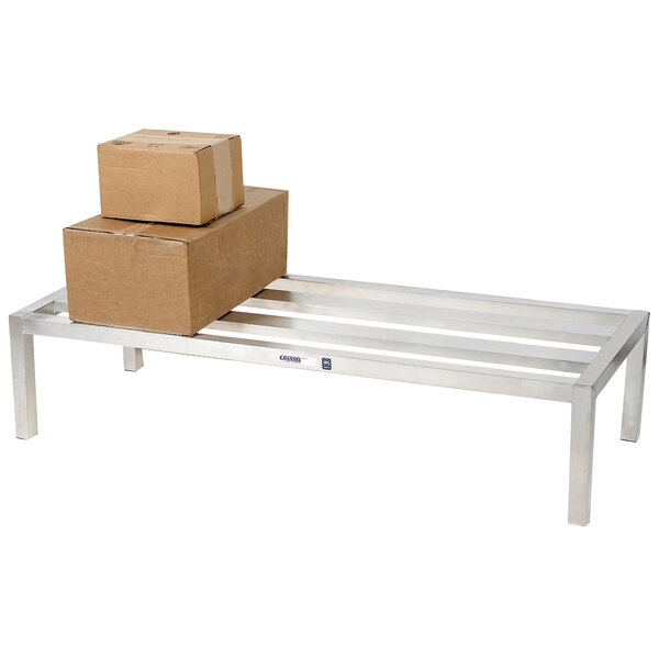 A stack of brown boxes on a Channel aluminum E-Channel dunnage rack.