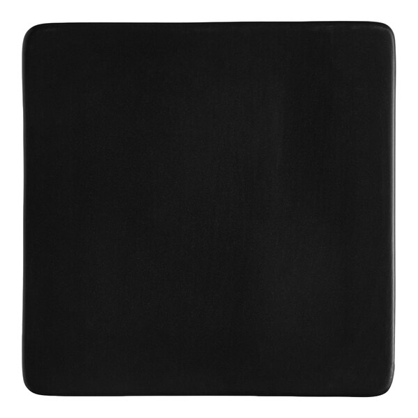 A square matte black stoneware flat plate.