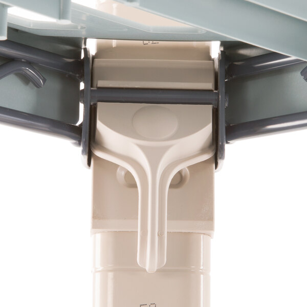 A close-up of a white plastic MetroMax Q shelving component.