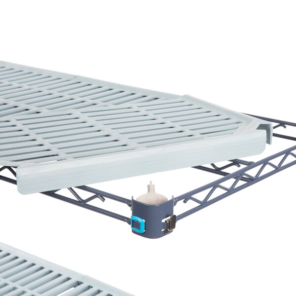 A MetroMax Q metal shelving unit with two shelves on a white table.