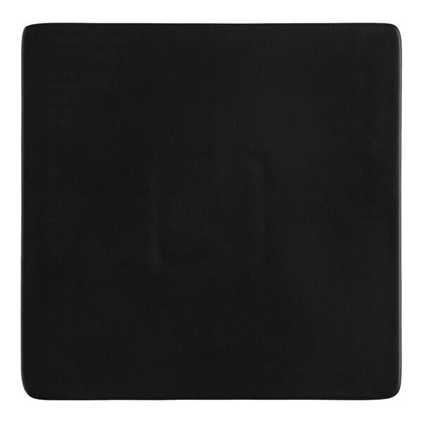 A square matte black stoneware flat plate.