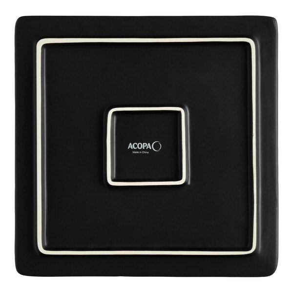 A matte black square stoneware flat plate with a minimalist design.