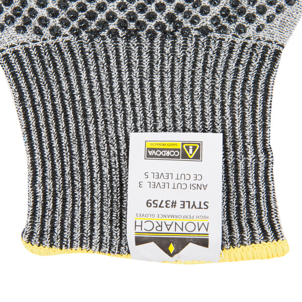A pair of Cordova Monarch heavy duty gloves with two-sided nitrile dotted coating and yellow dots on the back.