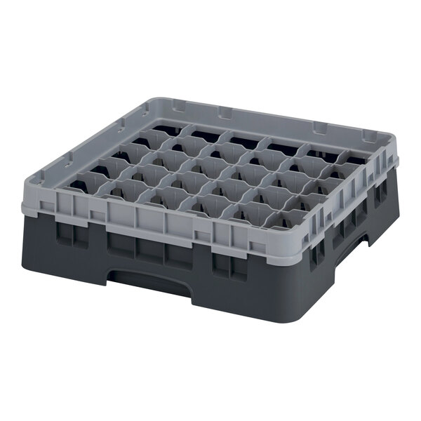 A black plastic Cambro glass rack with compartments and holes.