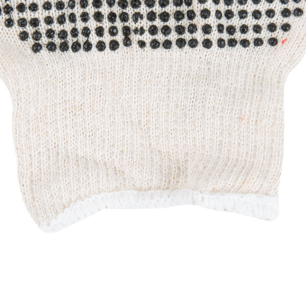 A close-up of a Cordova white polyester/cotton work glove with black PVC dots on it.
