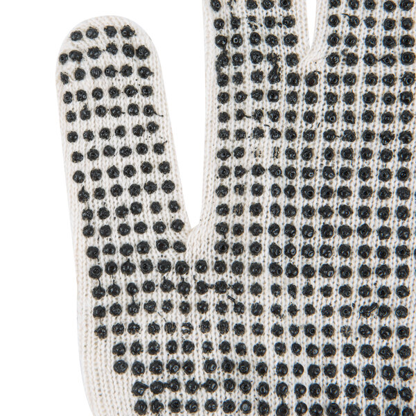 A close-up of a Cordova white work glove with black dots on the palm.