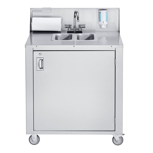 A stainless steel Crown Verity double bowl portable hand sink on a stainless steel cabinet with a roll of paper towels.