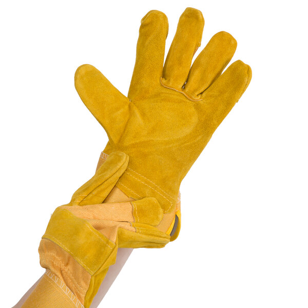 A hand wearing a yellow Cordova warehouse glove with russet leather palm coating.