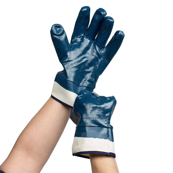 A pair of hands wearing blue Cordova warehouse gloves with white jersey lining.