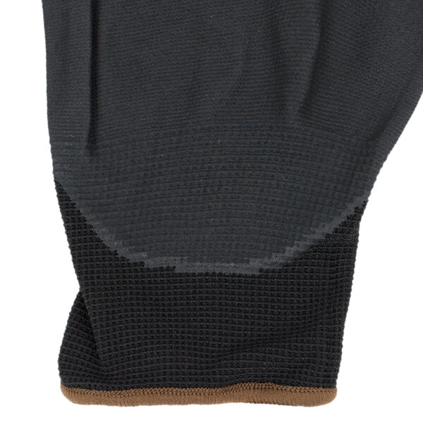 A pair of black Cordova warehouse gloves with a black and brown foam palm.