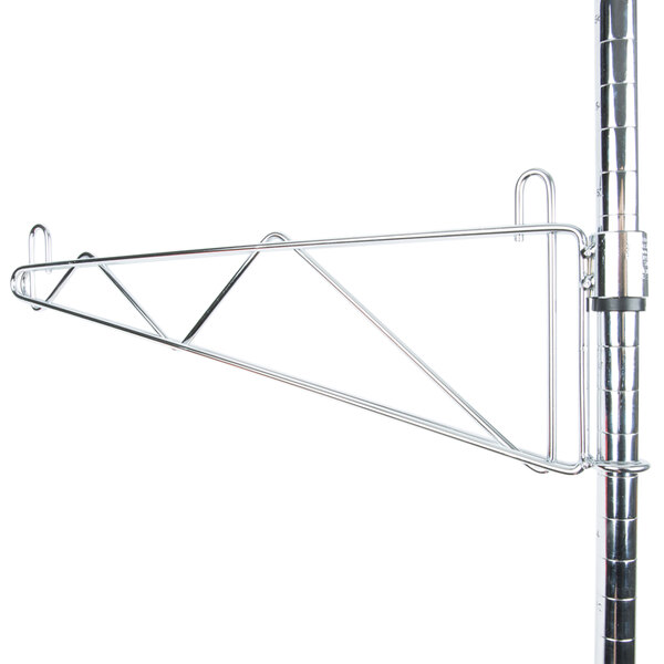 A Metro chrome shelf support pole with a metal bracket on it.