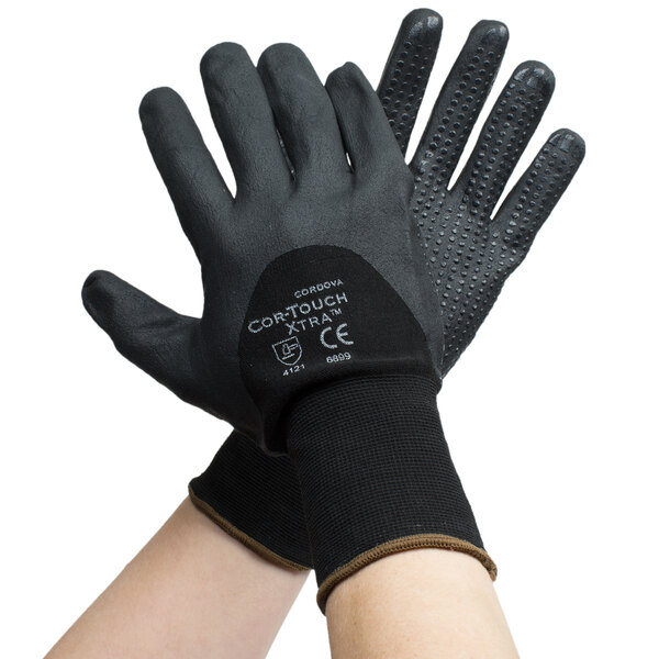 A pair of Cordova black gloves with black foam nitrile palms and nitrile dots on a white background.