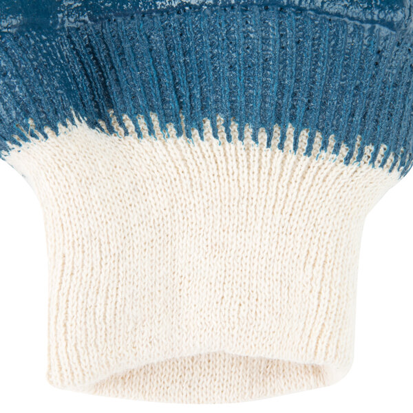 A blue and white Cordova knit glove with a white cuff.