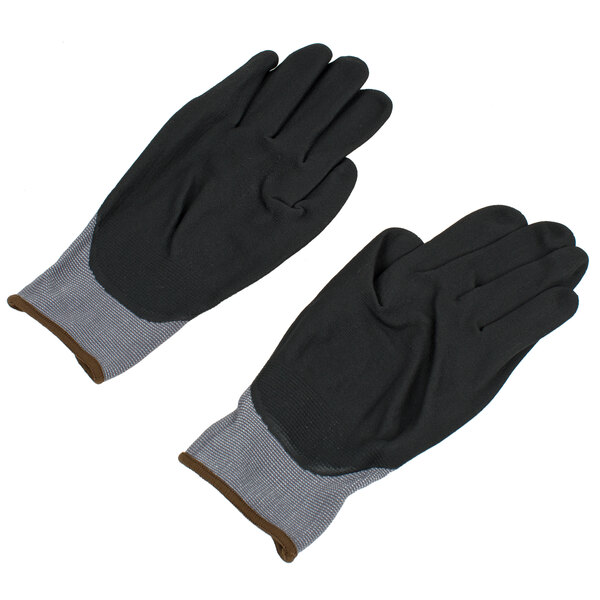 A pair of gray and black Cordova Conquest gloves with black foam nitrile palms and gray trim.