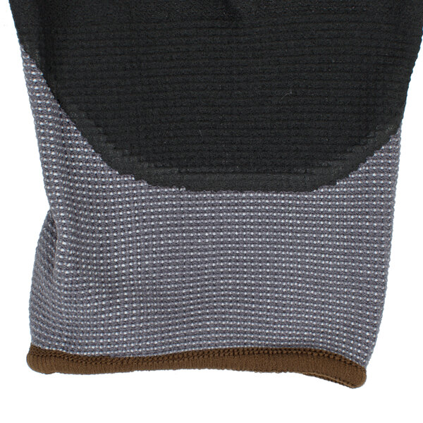 A close up of a gray Cordova Conquest glove with black palm coating.