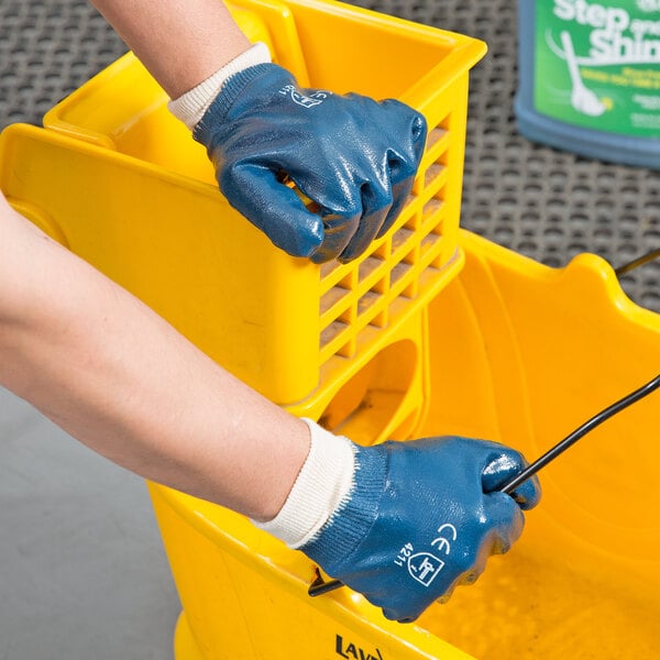 A person wearing Cordova blue nitrile gloves.