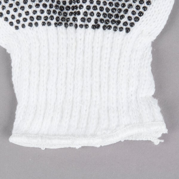 A white Cordova jersey glove with black PVC dots on the palm.