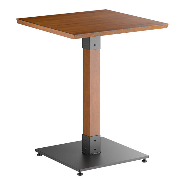 A square wooden table with a rustic walnut finish, supported by a central wooden pedestal and a black metal square base.