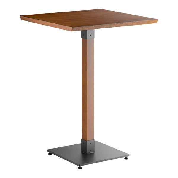 A square bar-height table with a rustic walnut-finished wooden top, a matching wooden central support, and a black metal square base.