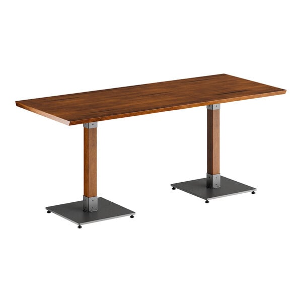 A Lancaster Table & Seating live edge table with metal legs and a wooden top.
