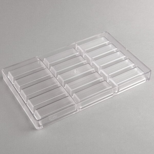 A clear plastic Chocolate World candy mold with rectangular compartments.
