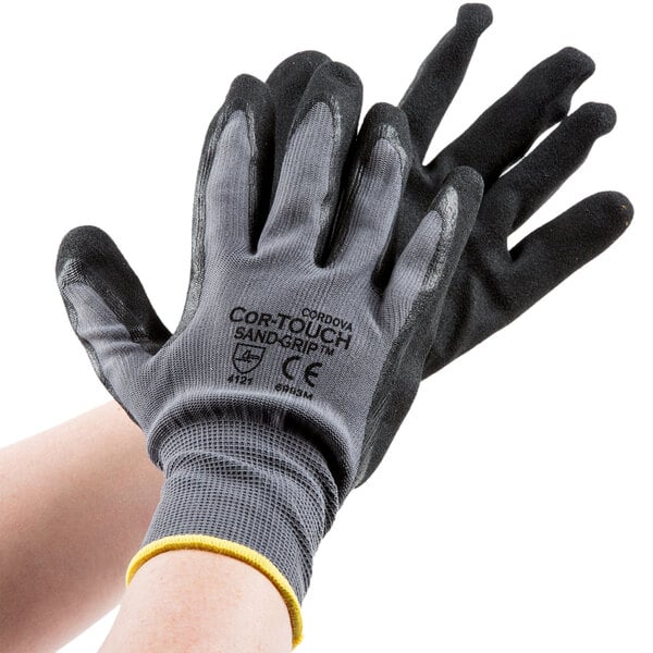 A pair of gray Cordova Cor-Touch gloves with black sandy nitrile palm coating.