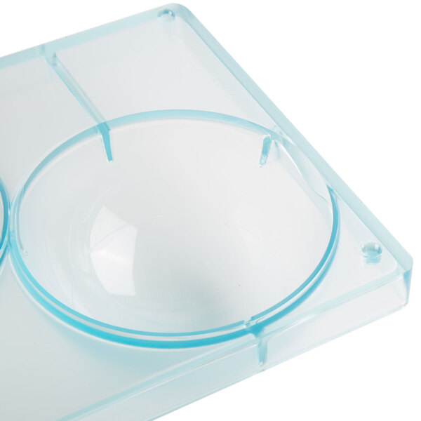 A clear polycarbonate tray with three half spheres.