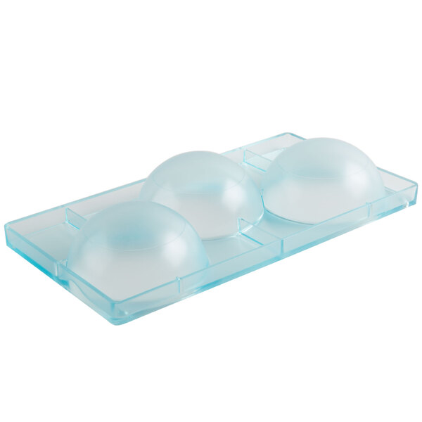 A clear plastic container with three round objects inside.