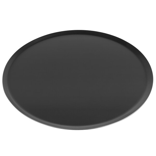 A black round Matfer Bourgeat carbon steel pizza pan.