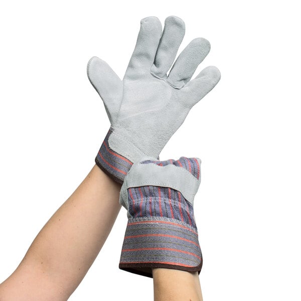 A pair of hands wearing Cordova striped canvas and leather work gloves.