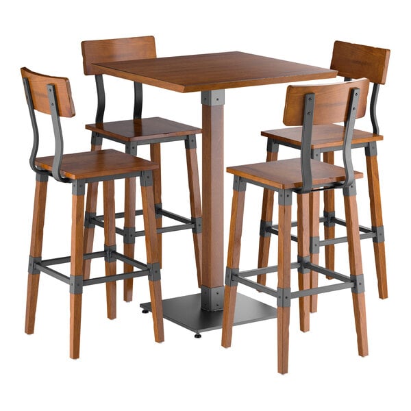 A bar-height table with a square wooden top and four matching wooden bar stools featuring metal accents and footrests.