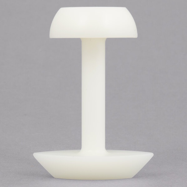 A white plastic Matfer Bourgeat double-sided molding stamp.