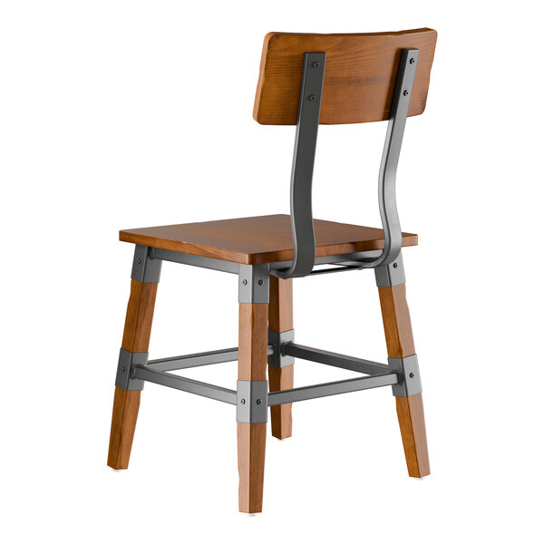 A wooden chair with a rustic walnut finish and metal supports, shown from the back.