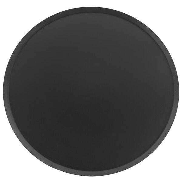 A black round Matfer Bourgeat carbon steel pizza pan.
