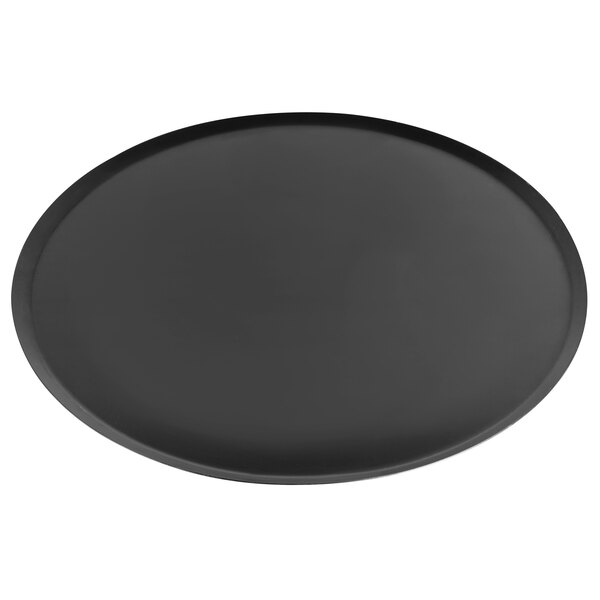 A black round Matfer Bourgeat carbon steel oven sheet with a round bottom.