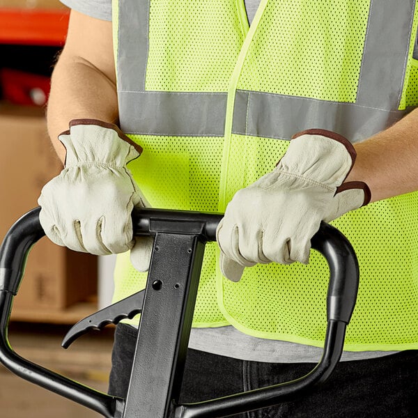 A person wearing Cordova Economy grain pigskin driver's gloves holding a forklift handle.