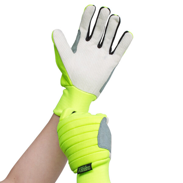 A person wearing a medium Cordova Colossus lime green warehouse glove.