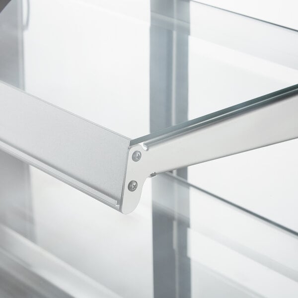 A close up of an Avantco curved glass shelf with metal handles.