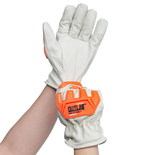 A pair of Cordova Outlaw leather gloves with orange and white trim and TPR protectors.