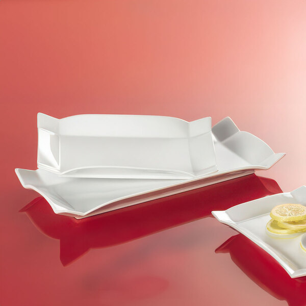 A CAC rectangular white china platter with a lemon slice on it.